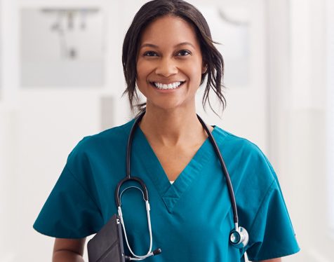 portrait-of-smiling-female-doctor-wearing-scrubs-i-TCZV5LZ.jpg